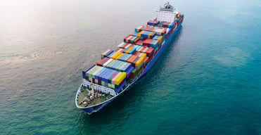 aerial-of-cargo-ship-carrying-container-and-runnin-2024-12-08-00-40-14-utc