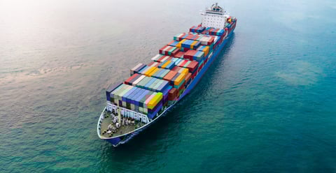 aerial-of-cargo-ship-carrying-container-and-runnin-2024-12-08-00-40-14-utc