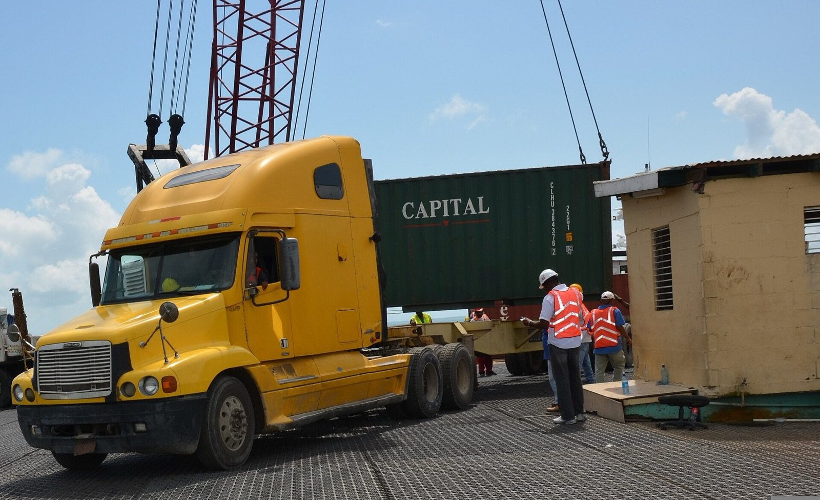 Truck and shipping container being offloaded at the Port of Belize, Belize City