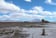 Freight train crossing the Bolivian Altiplano with Andean volcanoes in the background