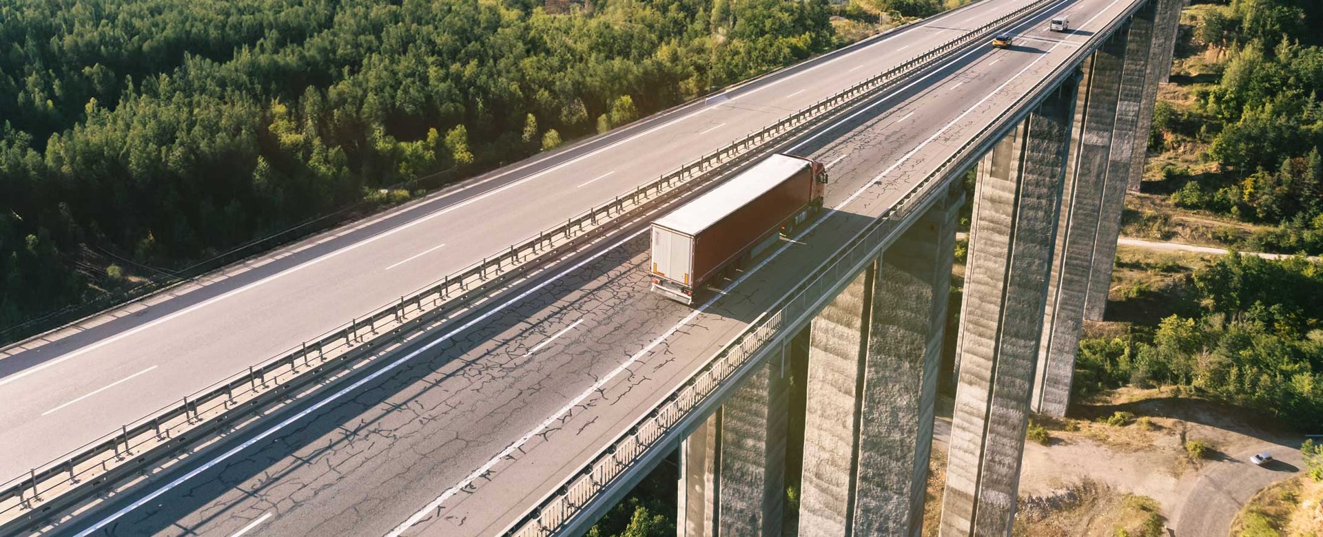 cargo-delivery-truck-driving-on-highway-bridge-on-2023-11-27-05-26-39-utc