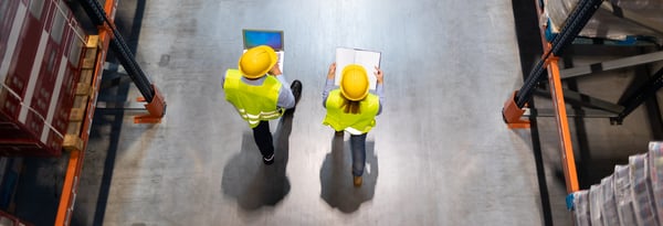 Warehouse staff reviewing a delivery plan